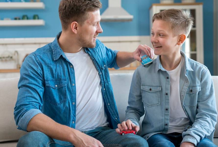 father-son-playing-with-toy-cars_23-2148511206