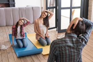 high-angle-family-yoga-sesion-home_23-2148542876