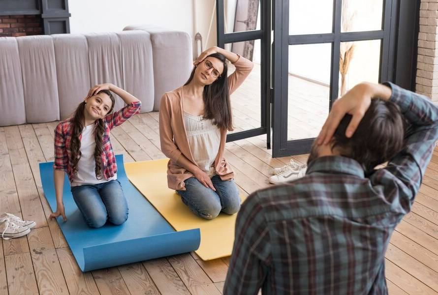 high-angle-family-yoga-sesion-home_23-2148542876