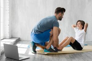 kid-his-father-doing-sport-home_23-2148553586